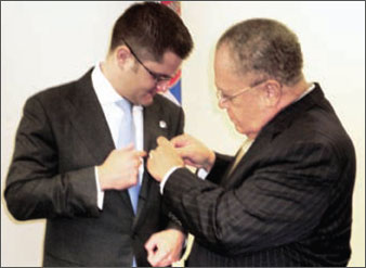 President of the General Assembly of the United Nations, Mr. Vuk Jeremić, being decorated with the FICAC Medal of Distinction by FICAC President, The Honourable Arnold Foote.